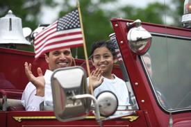 Third-grader Julian McRandal rides to school with his father in the front seat of a fire truck at Glenville School in the Glenville section of Greenwich, Conn. Tuesday, June 14, 2022. McRandal, who has brain cancer, was surprised Tuesday morning to be driven to school in a fire truck with a police motorcycle motorcade. The entire school was waiting outside to greet him, give him gifts, and honor him during a school assembly.

Tyler Sizemore / Hearst Connecticut Media
