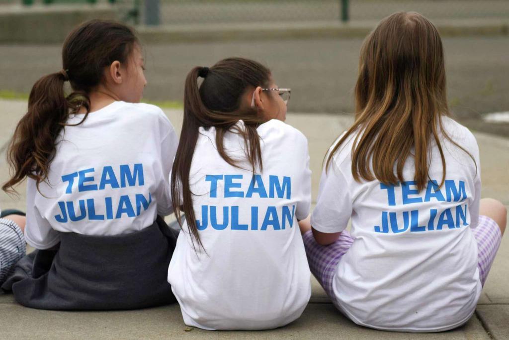 Julian McRandal's classmates wear Team Julian shirts at Glenville School in the Glenville section of Greenwich, Conn. Tuesday, June 14, 2022. McRandal, who has brain cancer, was surprised Tuesday morning to be driven to school in a fire truck with a police motorcycle motorcade. The entire school was waiting outside to greet him, give him gifts, and honor him during a school assembly.

Tyler Sizemore / Hearst Connecticut Media